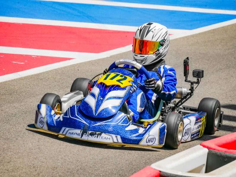 Reid Eck in kart #172 over the blue and red curbs at K1 Circuit