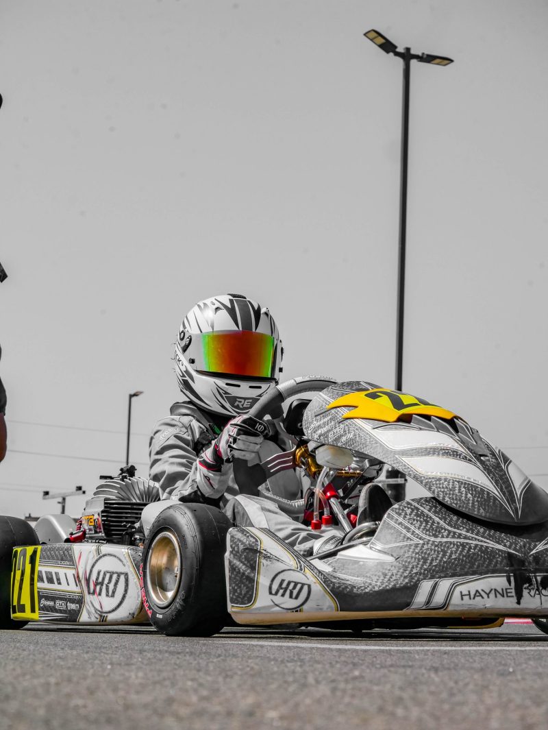 Reid Eck in kart #221, black and white with color helmet